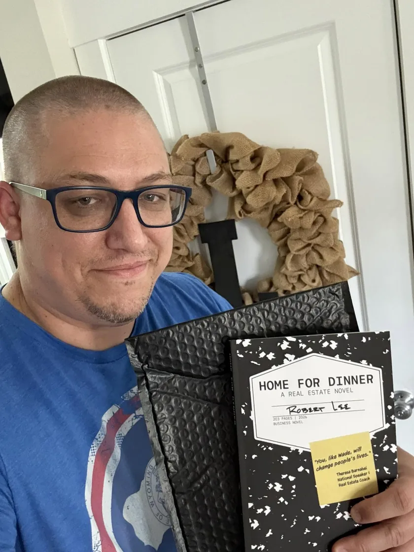 Robert Lee holding the printed proof of Home for Dinner: A Real Estate Novel